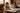 Mother and toddler stacking colourful wooden blocks on the living room floor