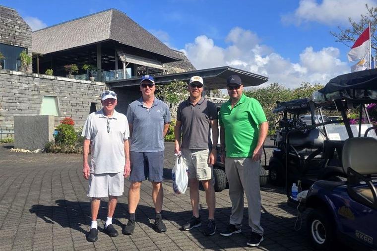 Four golfers outside the Bukit Pandawa Golf clubhouse before their round