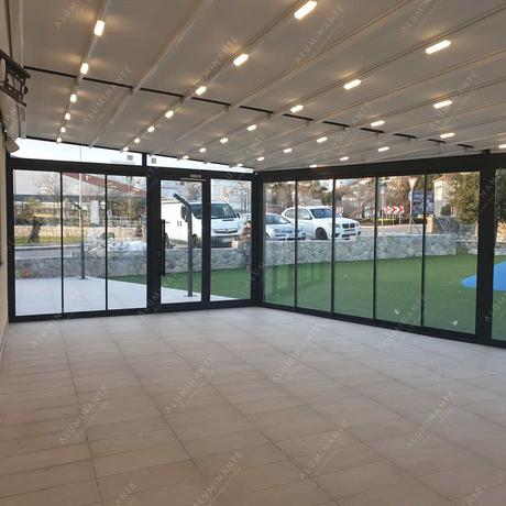 Restaurant with a retractable pergola and perimeter glazing