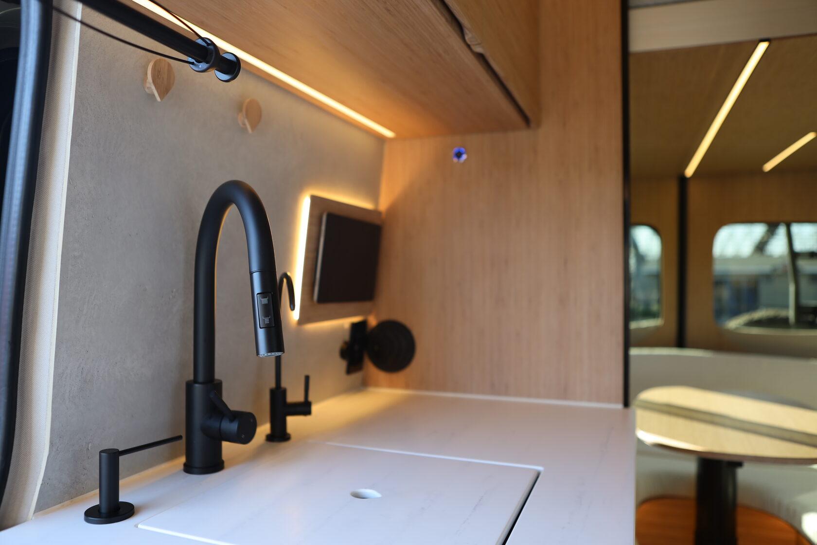 Aura galley kitchen with the lounge and dining area behind