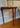 Three legged hand carved hall table with floral detail 