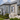 Professional painters priming and repainting an Auckland weatherboard villa exterior