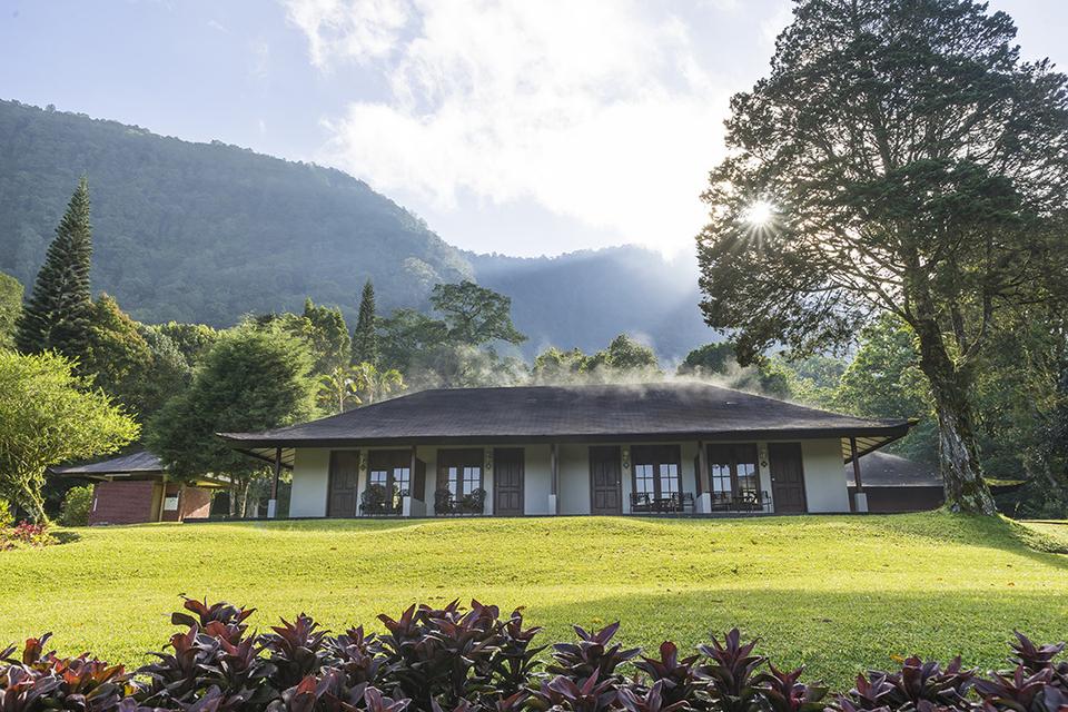 Handara Golf and Resort clubhouse below forested mountains