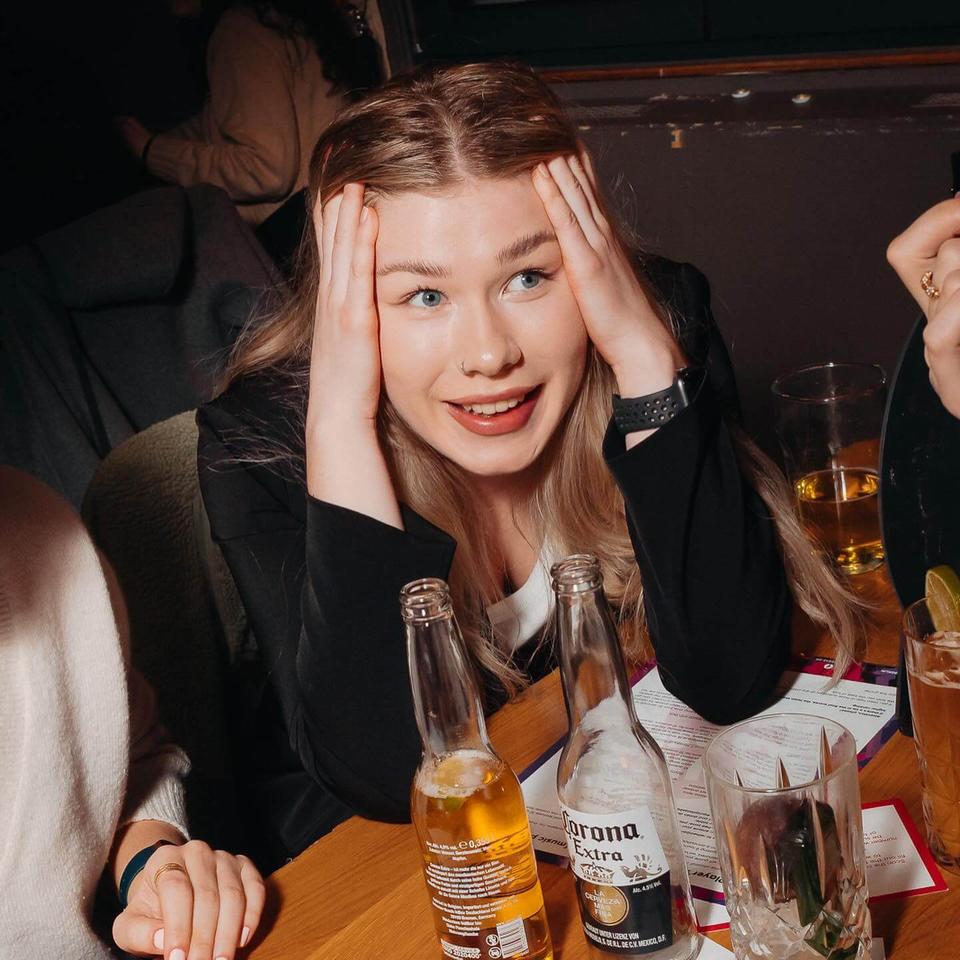 A player holding her head in disbelief at a quiz answer