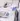 Lab worker in blue gloves using a scoop near a digital scale on a clean bench
