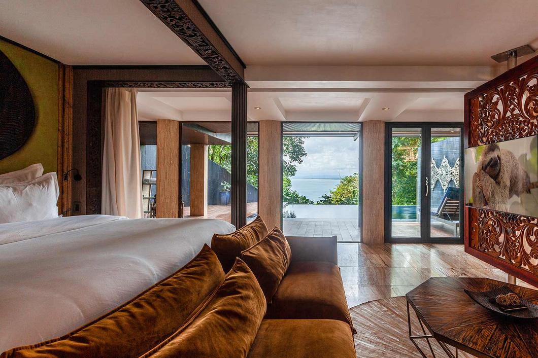 Luxury Villa Private Pool, bed and sofa, ocean beyond the glass, Hotel Makanda, Manuel Antonio