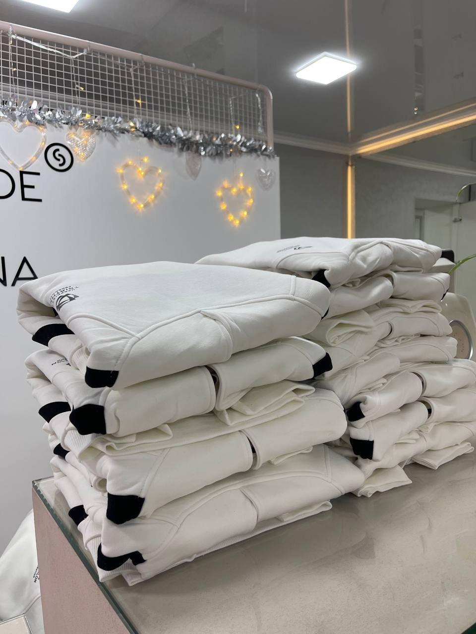 A batch of white hoodies for the Uzbekistan Triathlon Federation in the workshop