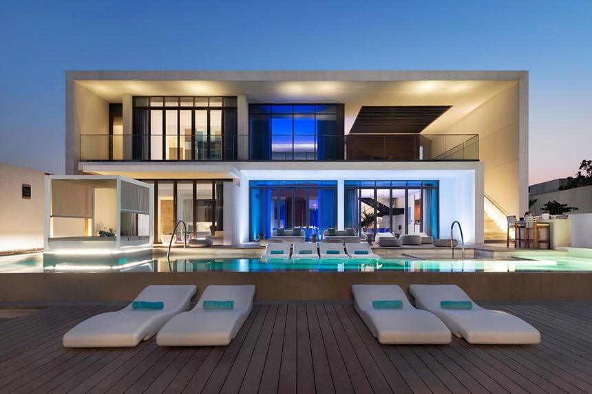 Modern home with a pool photographed at night