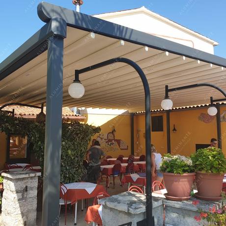 Restaurant summer terrace with a wall-mounted retractable pergola