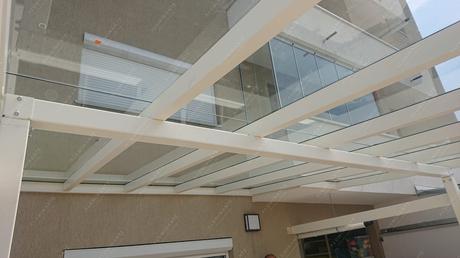 Transparent PRADA glass roof canopy over a house terrace