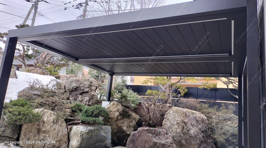 Wall-mounted louvered pivot-sliding pergola in two modules
