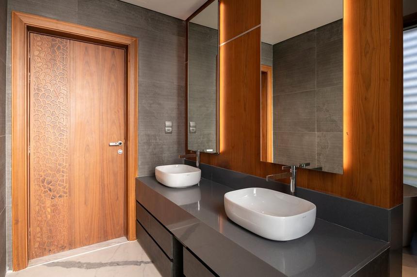 Modern bathroom with a stone counter and wood panels