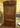 Historic church display cabinet in stained wood with hand carved dove