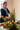 Participant learning floral techniques and working with fresh seasonal flowers during a brand workshop in Belgium