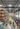 Large warehouse store with palletized products, storage racks, and customers shopping in bulk