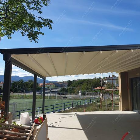 House summer terrace with a wall-mounted retractable pergola