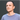 a white man in a blue jumper