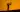 Silhouette of a woman playing a frame drum on a dune against an orange sunset sky