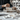 Architect working on a scaled model of a modern house, illustrating the design process of residential architecture.