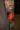 Realistic arm tattoo featuring a detailed portrait of a Black woman with an intense expression above orange flames and a greenish face