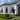 Renovation specialist inspecting the finished exterior paintwork on an Auckland home
