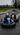 Blue and orange karts racing closely on a wet track at Athboy Karting Centre