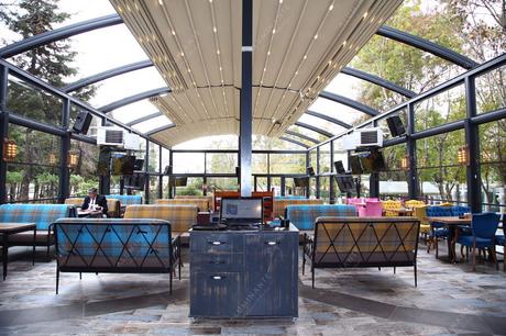 Oval retractable pergola with SKYLINE guillotine glazing