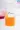Glass with orange B Vitamin liquid