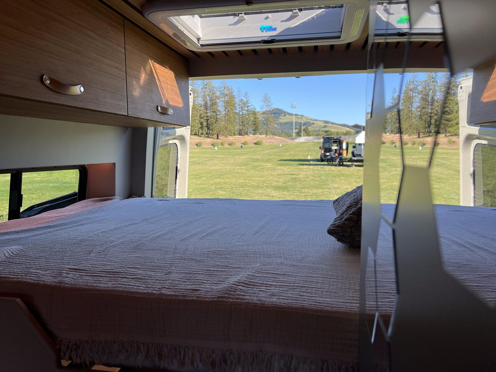 Aura permanent queen-size bed with a view through the rear doors
