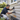 Specialist inspecting and repairing weatherboard cladding before exterior painting