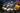 Multiple street food dishes cooked on woks