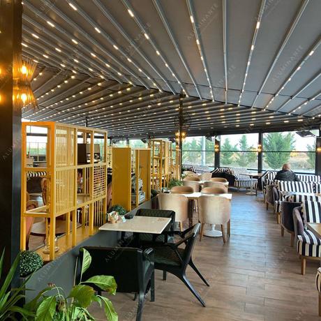 Retractable pergola with perimeter guillotine glazing