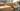 Cardboard shipping boxes with barcode labels moving through a warehouse conveyor system