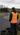Track marshal watching blue and orange karts from behind the tyre barrier at Athboy Karting Centre