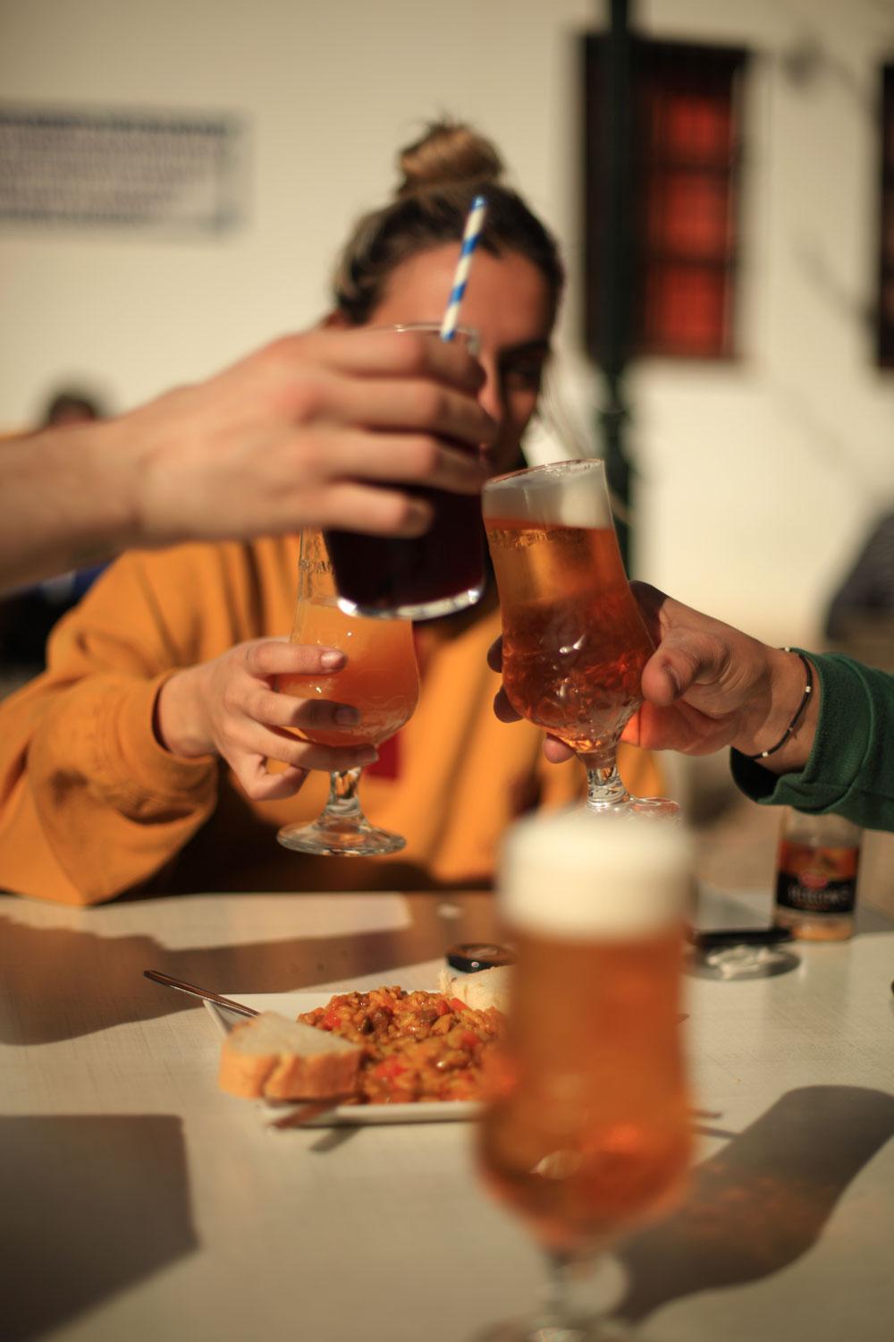 Friends toasting with beers and tapas in Granada