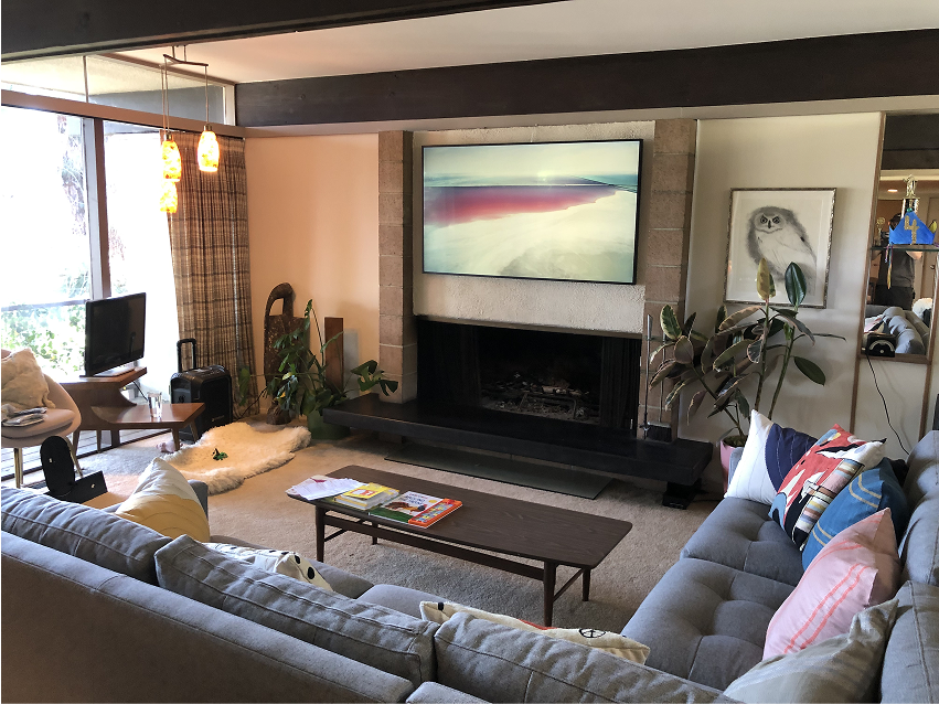 Television in art mode above the fireplace